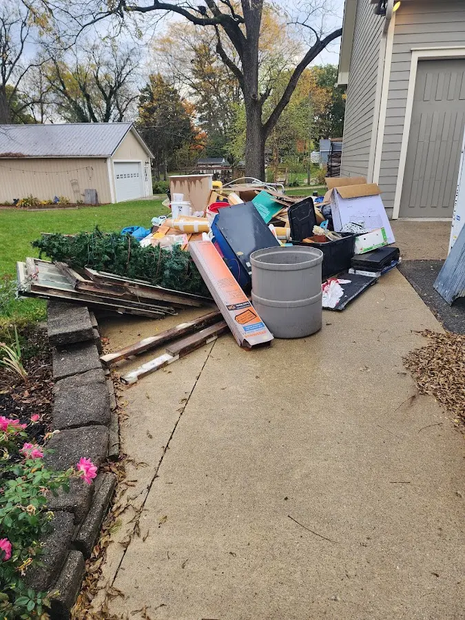 Dumpster being loaded with debris for Residential Dumpster Rental in Brighton